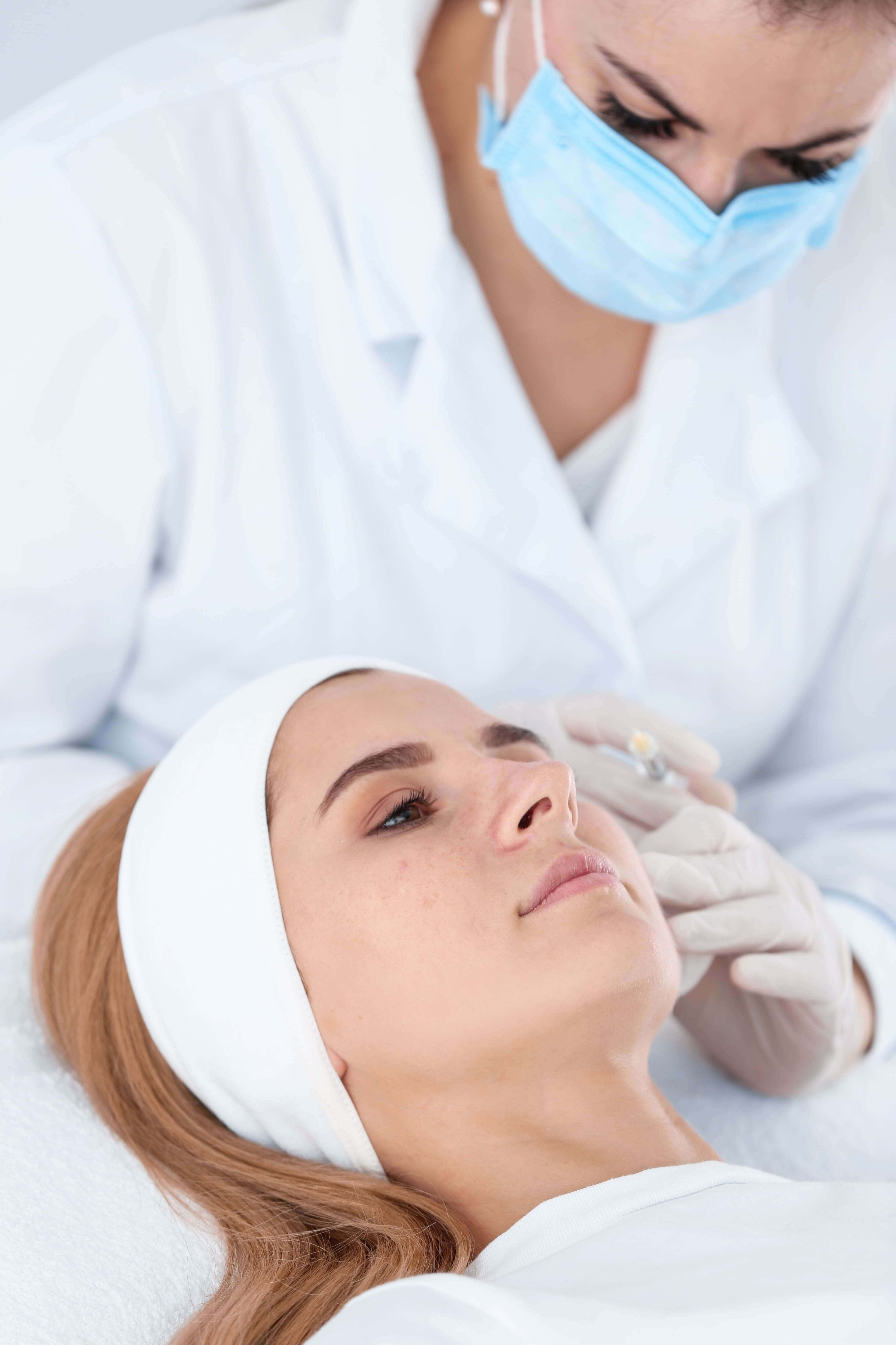 A patient receives Radiesse dermal filler in her face