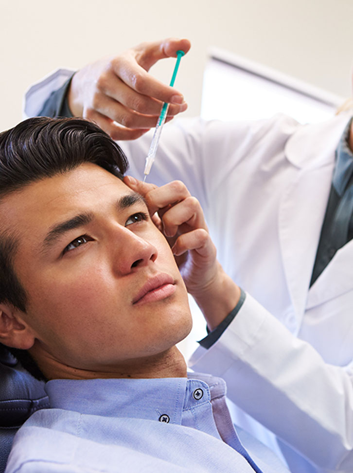 A man receives medical Botox treatment for pain