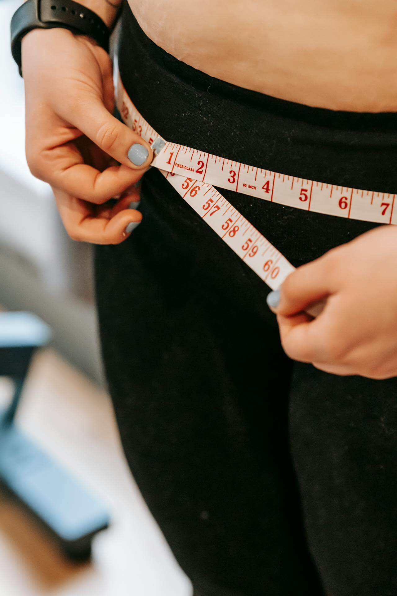 a woman measuring her hips