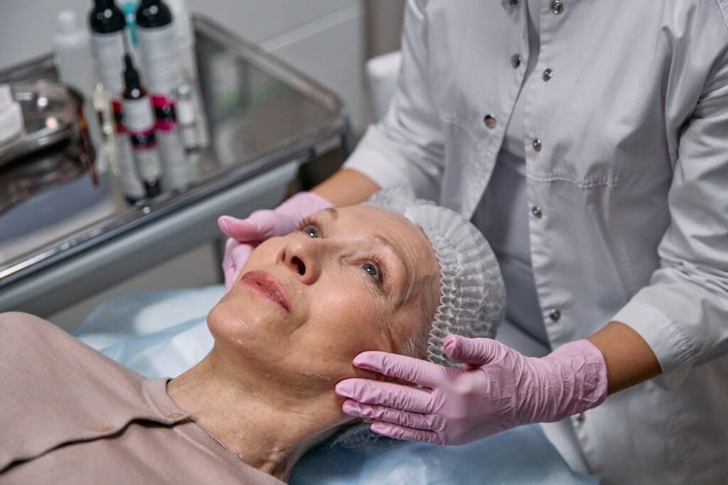 Older woman laying down for dermal filler procedure