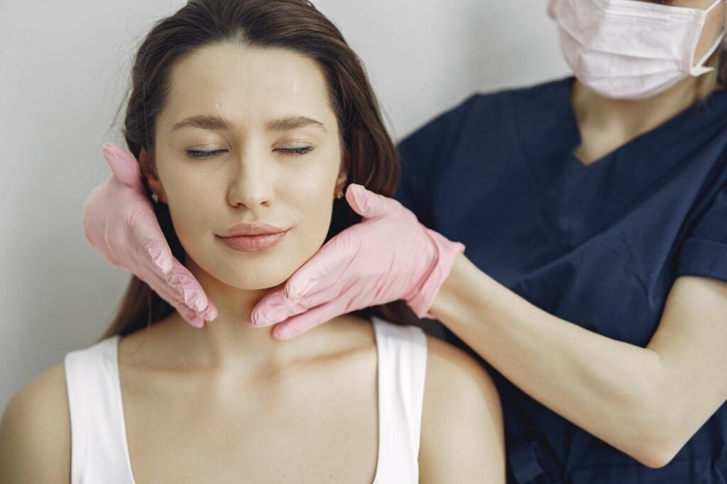 Female patient in white top with doctor post procedure