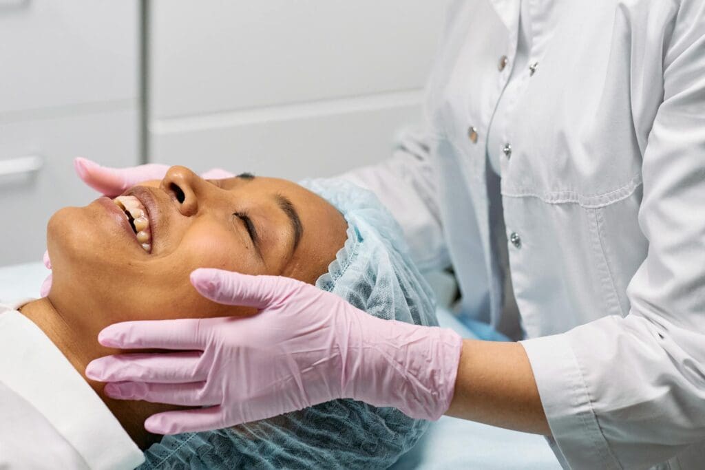 A smiling woman on a bed after her medical appointment 