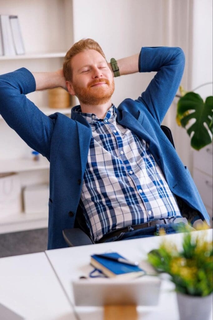 A businessman relaxes at his desk