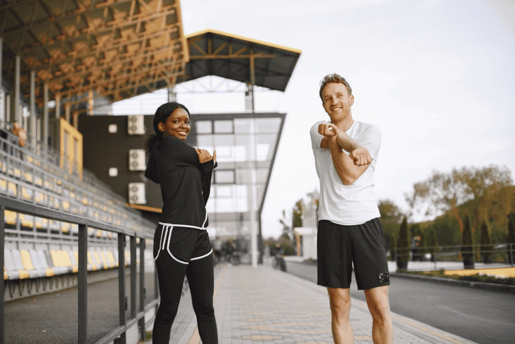 Two casual athletes stretching before exercise